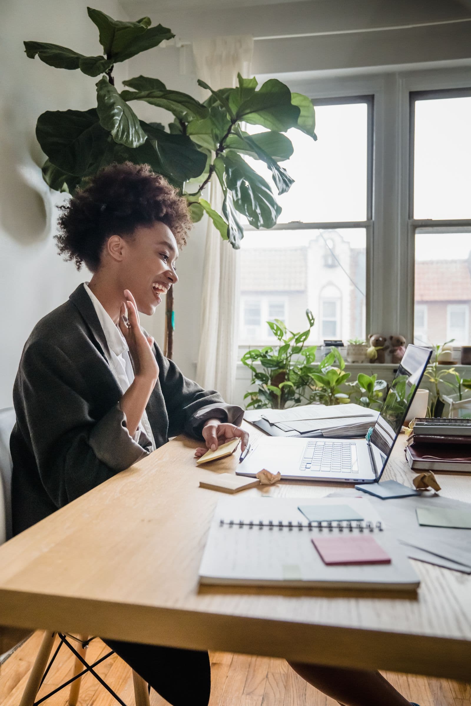 A coach in a video coaching session from a bright home office