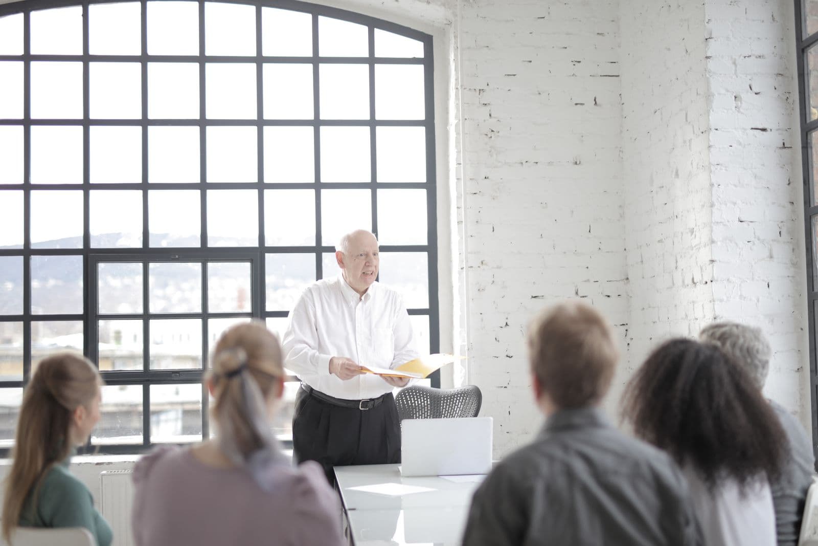 A senior faculty member leading an advanced coaching practicum